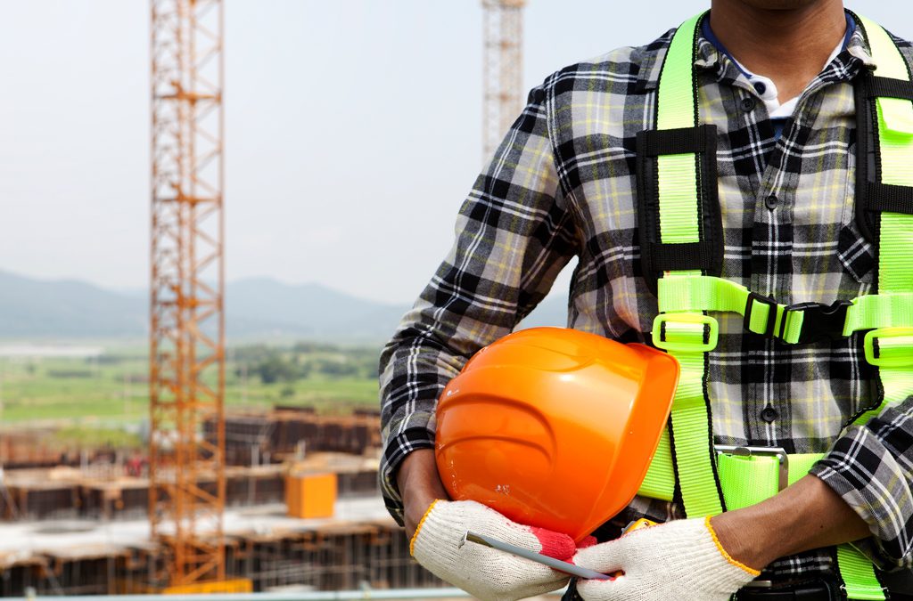 Close up construction worker holding helmet